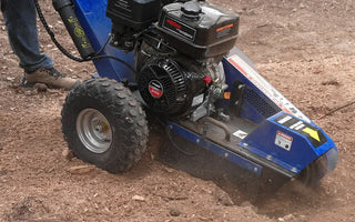 Operator using a gas stump grinder outdoors