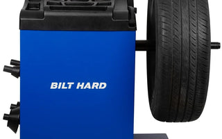 Wheel balancing machine with mounted passenger car tire