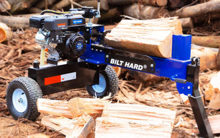 Log splitter surrounded by split firewood for seasonal fireplace maintenance