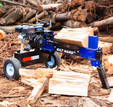 Log splitter surrounded by split firewood for seasonal fireplace maintenance