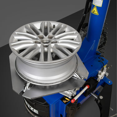 BILT HARD tire changer mounting an alloy wheel