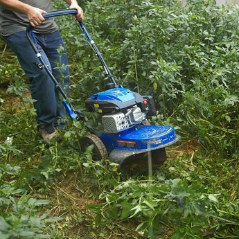 BILT HARD walk-behind brush mower clearing dense vegetation