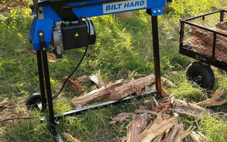 Split firewood beside log splitter ready to season outdoors