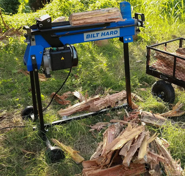 Split firewood beside log splitter ready to season outdoors