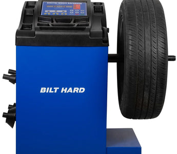 Wheel balancing machine with mounted passenger car tire