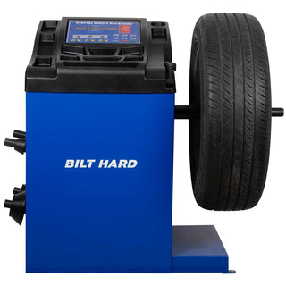 Wheel balancing machine with mounted passenger car tire