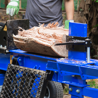 Hydraulic log splitter cutting a tough hardwood log